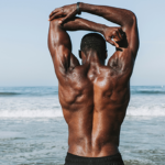 Man stretching arm and back muscles